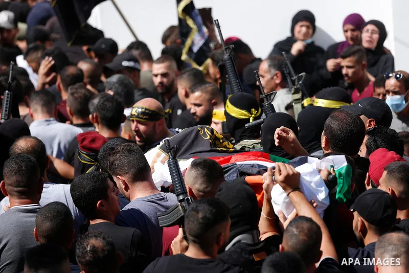 Mourners carry the body of Osama Sobh, a Palestinian man killed by Israeli soldiers during clashes near Jenin, during his funeral in the village of Burqin in the West Bank on September 26, 2021. The Palestinian health mi...