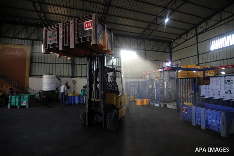 Palestinian workers prepare olives before crushe it to change-over into oil in an olive oil processing workshop, in Khan Younis in the southern of Gaza strip, on September 28, 2021. The 2021 olive harvest season, was an...