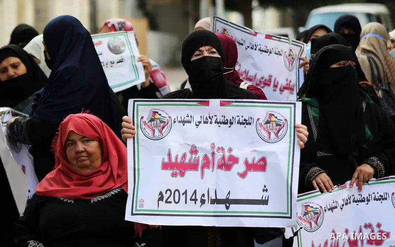 Families of Palestinian martyrs and wounded, take part in a protest against the Palestinian Authority's decision to cut their salaries for seven years, in Gaza City on September 28, 2021. In January 2019, the PA cut the...