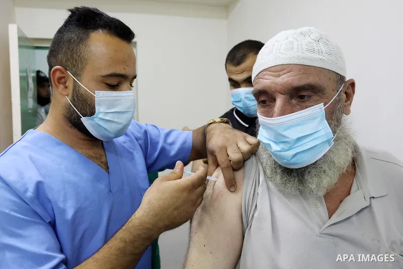 Palestinians get inoculated with a dose of the Covishield vaccine against the Covid-19 coronavirus, at a temporary vaccination centre set up, in Deir al-Balah in the center of Gaza Strip on September 28, 2021. Photo by A...