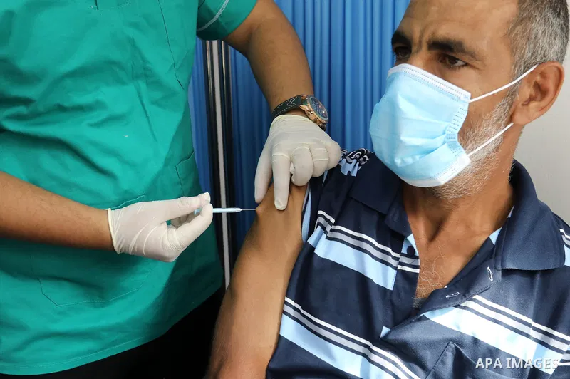 Palestinians get inoculated with a dose of the Covishield vaccine against the Covid-19 coronavirus, at a temporary vaccination centre set up, in Deir al-Balah in the center of Gaza Strip on September 28, 2021. Photo by A...