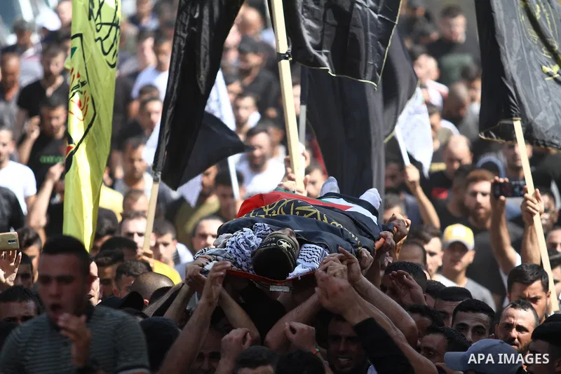 Palestinians carry the body of member of Islamic Jihad Alaa Zayoud, 22, who was killed in clashes with Israeli forces earlier, during his funeral at his village of Silat al-Harithiyah, east of Jenin in the occupied West...