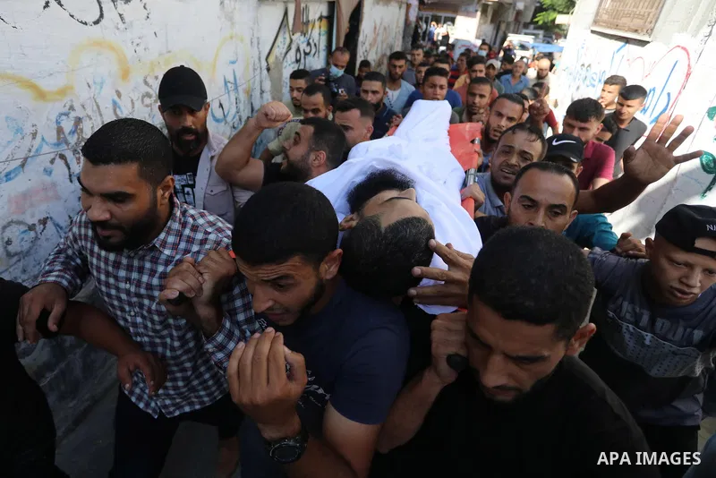 Mourners attend the funeral of Mohammad Abu Ammar, 40, a Palestinian who was killed by Israeli fire at the Israel-Gaza border fence, according to health ministry, in Bureij in the central Gaza Strip on September 30, 2021...
