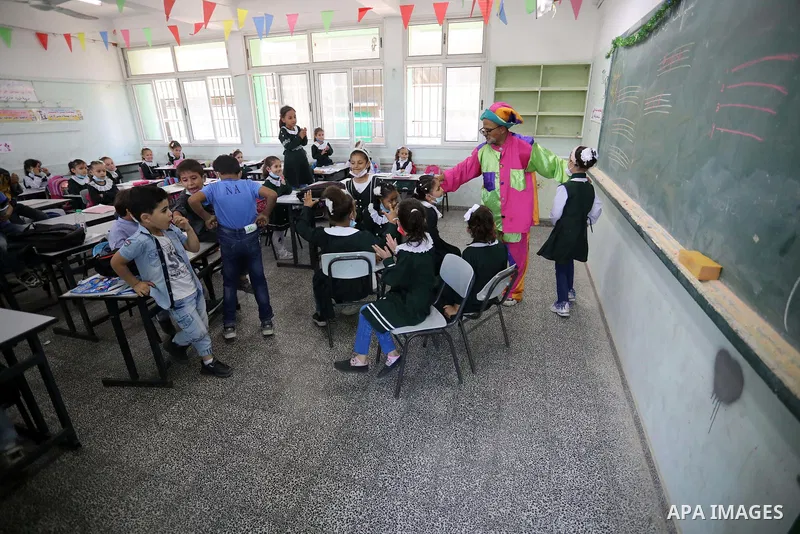 A Palestinian English language teacher, Louay Sheikh Eid, dressed as a clown while teaching school students, in Khan Younis in the southern Gaza strip on October 4, 2021. Sheikh Eid said that he started using this method...