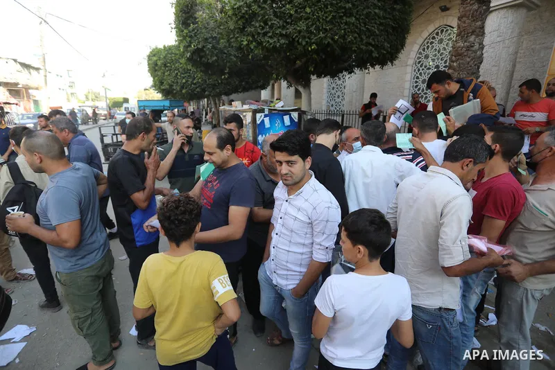 Palestinian citizens waiting in front of the Gaza Chamber of Commerce and Industry ​headquarters to register in order to work inside the Israel territories, in Jabalia, northern Gaza Strip, on October, 06 2021. The Gaza...