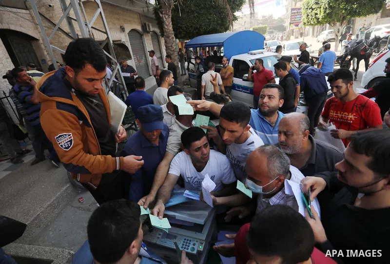 Palestinian citizens waiting in front of the Gaza Chamber of Commerce and Industry ​headquarters to register in order to work inside the Israel territories, in Jabalia, northern Gaza Strip, on October, 06 2021. The Gaza...