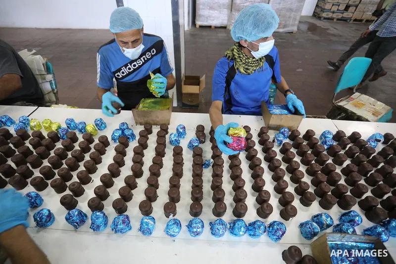 Palestinian workers prepare the vanilla candy known as "Ras El-abed or Shatawi" in the sweet factory , in Deir al-Balah, central Gaza Strip on October 7, 2021. “Ras el Abed” means “Head of Slave”. We would often laugh ab...