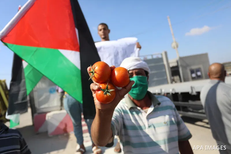 Palestinian farmers and traders take part in a protest against Israeli authorities a new restriction on them in front of the Kerem Shalom crossing in Rafah in the southern Gaza Strip, on October 10, 2021. Israeli authori...
