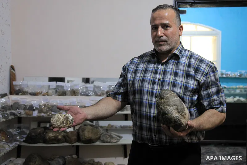 Palestinian man Salah al-Kahlout, 53, displays semi-precious stones at the Palestine Center, in Jabalia camp, in the northern Gaza Strip, on Ocotber 11, 2021. Al-Kahlout collects semi-precious stones to know their name a...