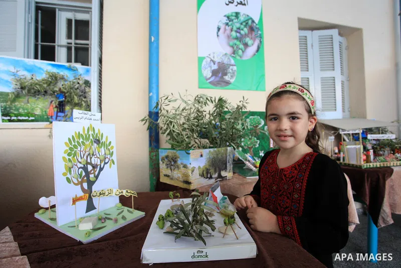 Palestinian children participate in an olive exhibition, in Gaza city on October 14, 2021. The 2021 olive harvest season, was an exceptionally poor one in terms of oil yield. Olive harvest season, is considered one of th...