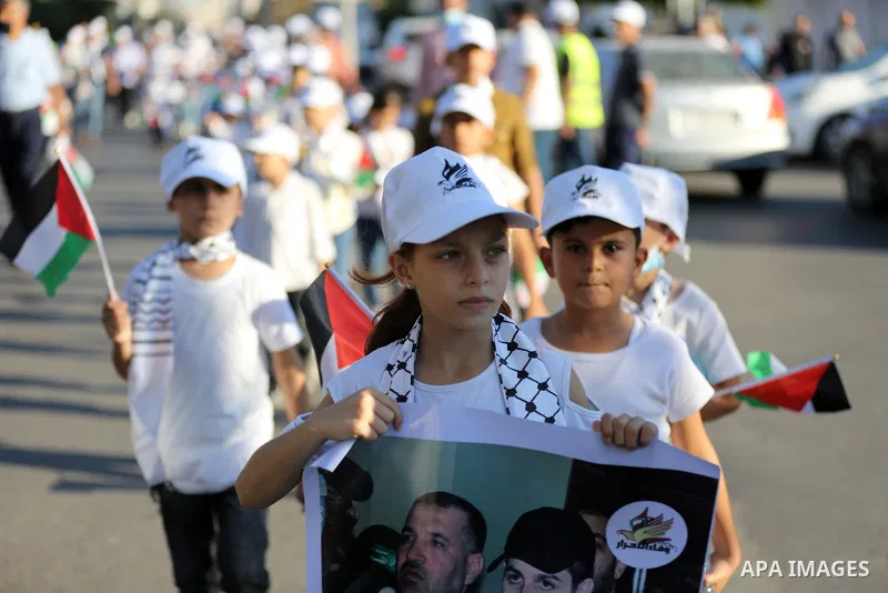 Palestinians take part in a march marking the 10th anniversary of prisoners swap deal between Hamas and Israel, in Gaza city on October 18, 2021. October will mark a decade since the last major swap deal between Israel a...