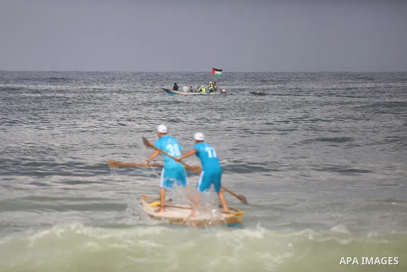 Palestinian players take part in the first sailing and rowing championship on the shore of the Mediterranean, in Gaza city, on Ocotber 20, 2021. The Palestinian Sailing and Rowing Federation organized the first sailing a...