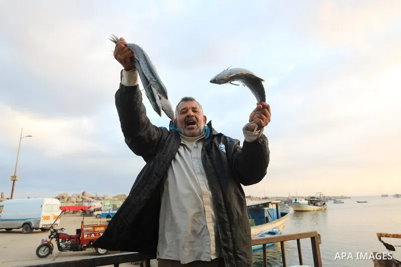 Palestinian fishermen sell fish at Gaza City's main port on October 21, 2021. Fishing is a major source of revenue for the impoverished Palestinian enclave. Israel, which maintains a blockade on Gaza strip, has over the...