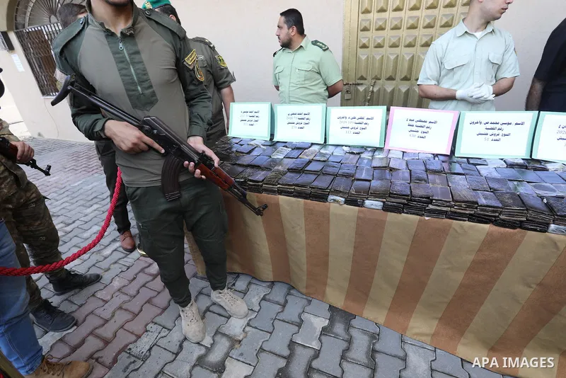 Members of Palestinian anti-drug police display the drugs during a press conference for the destruction of narcotics, in Gaza City on October 21, 2021. Photo by Ashraf Amra