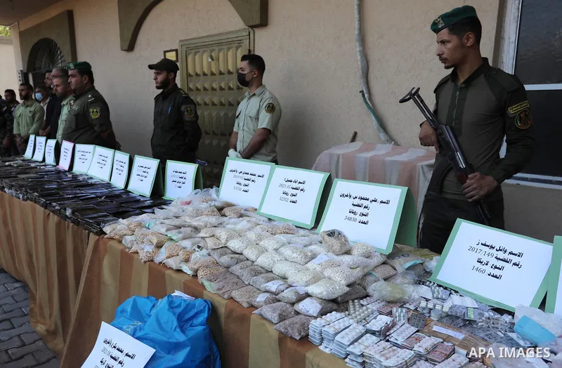 Members of Palestinian anti-drug police display the drugs during a press conference for the destruction of narcotics, in Gaza City on October 21, 2021. Photo by Ashraf Amra