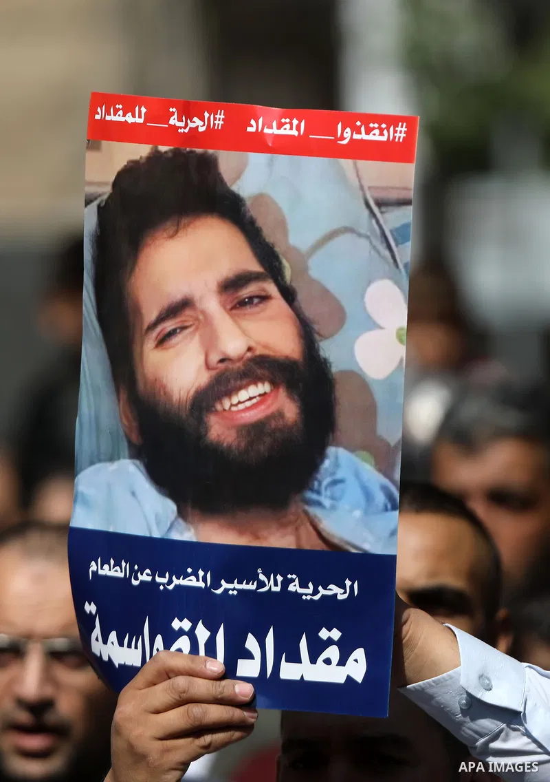 Palestinians take part in a rally in solidarity with prisoners on hunger strike at Israeli jails, in the West Bank city of Hebron on October 22, 2021. Israel is imprisoning some 4,650 Palestinian political prisoners. Ten...
