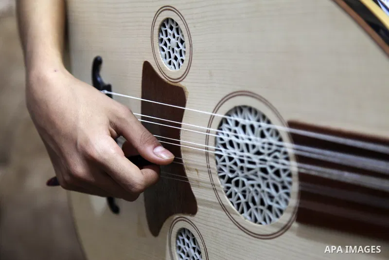 Palestinian boy Samih al Madhoun, 14, plays the oud and sings at his home, in Gaza city on October 26, 2021. al-Madhoun said that the passion for singing and composing is a talent that I worked a lot on developing and br...