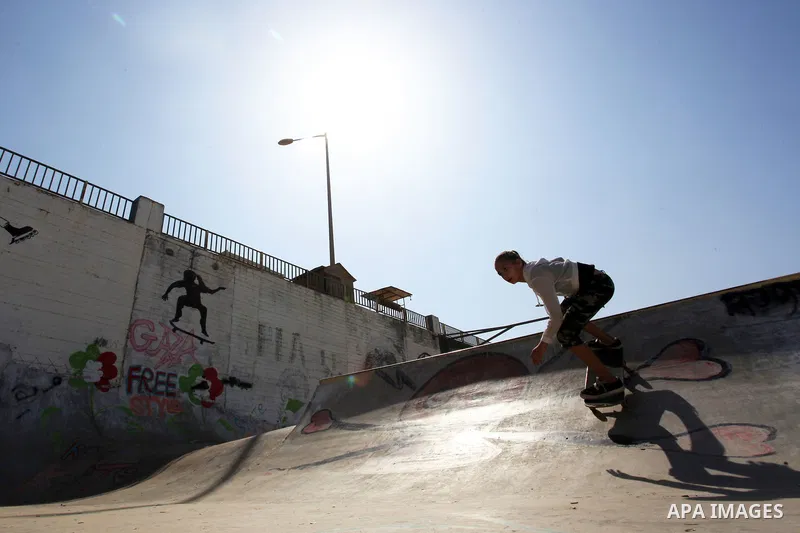 Palestinian girls practice on Skateboard sport at Gaza seaport, in Gaza city on October 27, 2021. A skateboard is a type of sports equipment used for skateboarding. They are usually made of a specially designed 7-8 ply m...