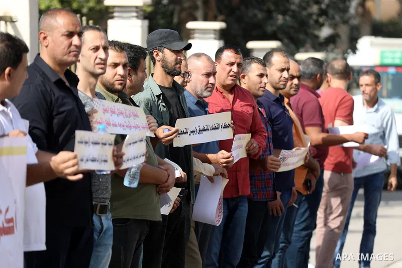 Employees of the Palestinian Authority whose salaries have been cut participate in a protest to demand the return of their salaries in front of the European Union headquarters in Gaza city on October 28, 2021. Photo by R...