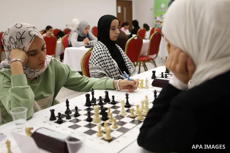 Palestinian girls play chess during Palestinian Chess Championship for Women 2021, which organized by Palestinian Chess Federation, in the West Bank city of Hebron on October 30, 2021. Photo by Mamoun Wazwaz