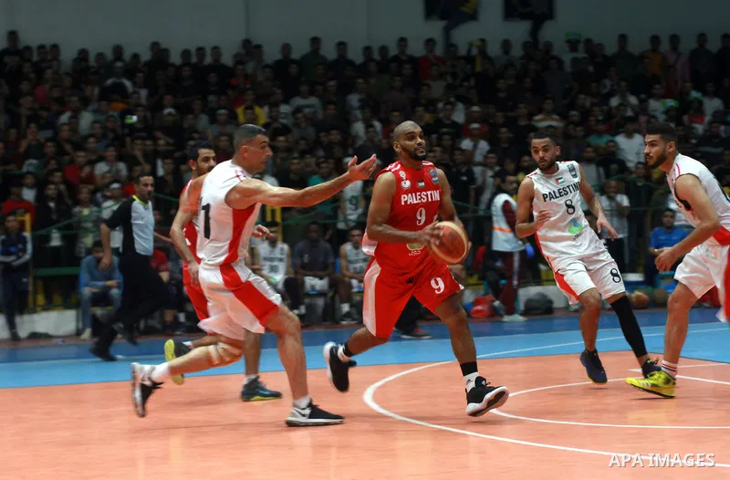 Palestinian basketball players of Khadamat al-Burij club and khadamat Maghazi compete during league, in Gaza City on October 30, 2021. Photo by Ali Hamad