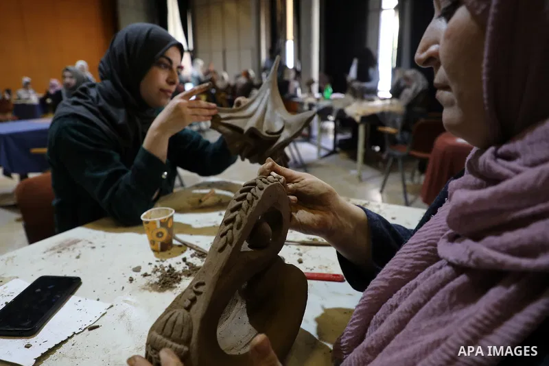 Palestinian women display thier handmade during an exhibition inside Rashad Shawa Cultural Center, in Gaza city on November 1, 2021. Photo by Majdi Fathi