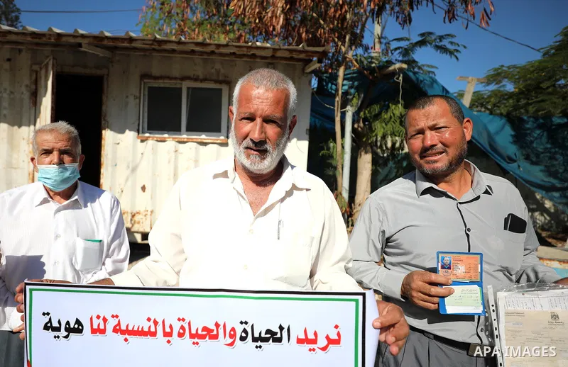 Palestinians hold IDs and banners to demand of the family reunification in front of the headquarter United Nation "UNSCO" in Gaza city, on 07 November 2021. Thousands of Palestinians have suffered as a result of the law,...