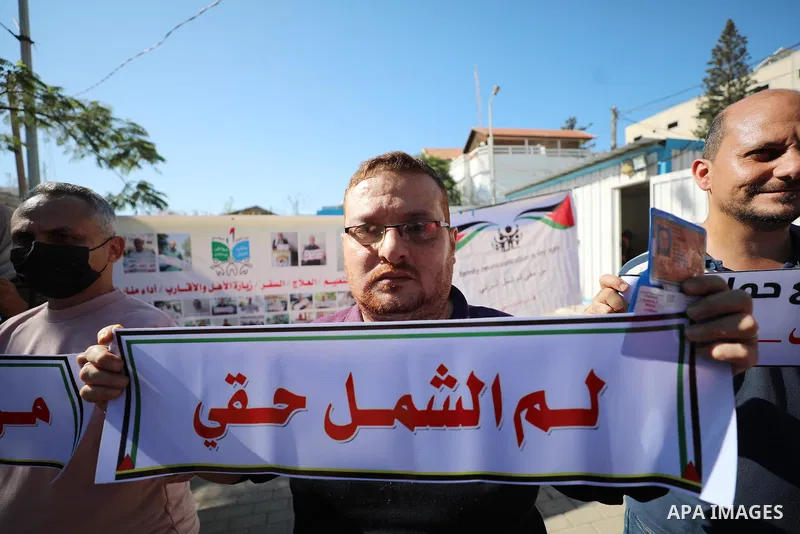 Palestinians hold IDs and banners to demand of the family reunification in front of the headquarter United Nation "UNSCO" in Gaza city, on 07 November 2021. Thousands of Palestinians have suffered as a result of the law,...