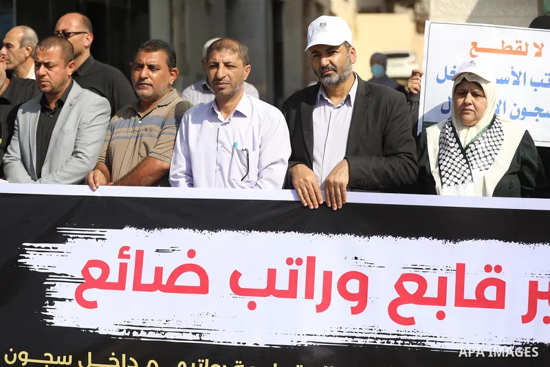 Palestinians take part in a protest against cutting the salaries of prisoners in Israeli Jails, in Gaza city on November 11, 2021.=. Photo by Ashraf Amra
