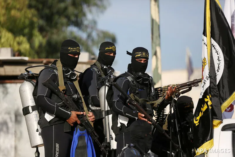 Palestinian militants from the Al-Quds Brigades, the armed wing of the Islamic Jihad movement, take part in a military parade to mark the seconed anniversary of killed of Islamic Jihad commander, Bahaa Abu el-Atta, in Ga...