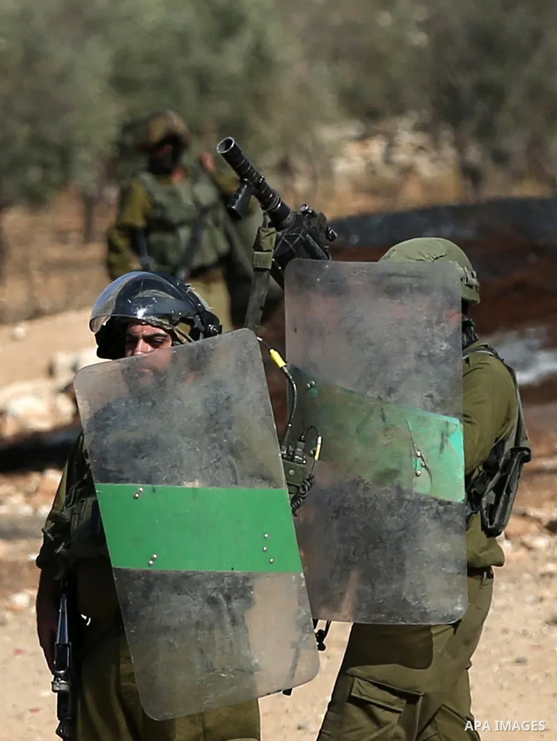 Palestinian protesters clash with Israeli security forces, during a demonstration against the establishment of Israeli outposts on Palestinian lands, in Beit Dajan, east of Nablus in the West Bank, on November 12, 2021....