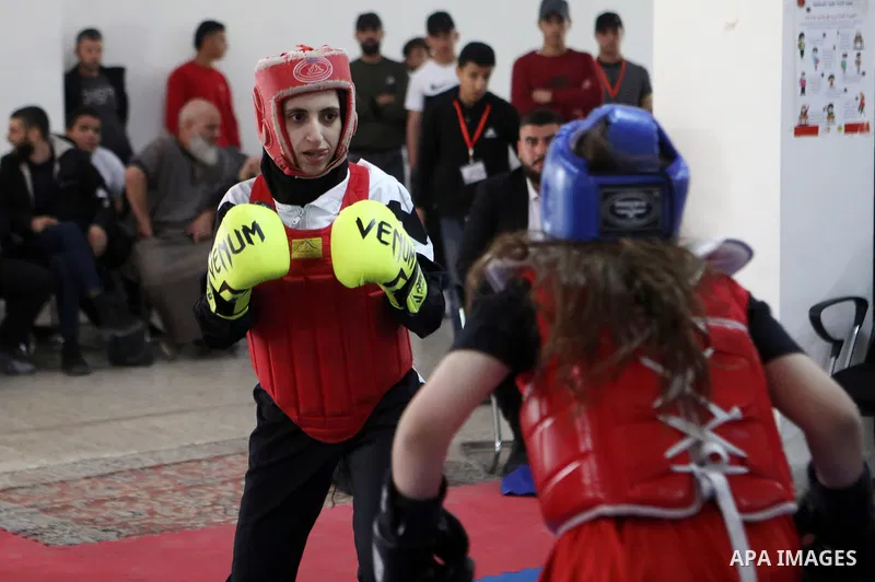 Palestinian youths fight during Wushu (Kung Fu) championship, in the West Bank city of Hebron, on November 12, 2021. Wushu or Kungfu, is a hard and soft and complete martial art, as well as a full-contact sport. Photo by...