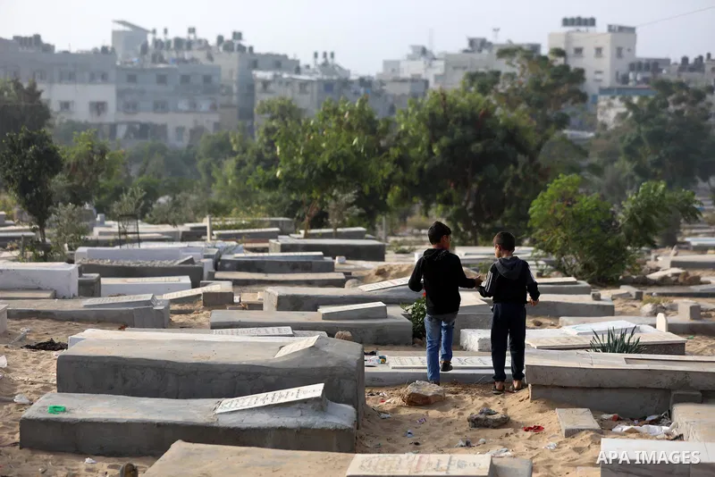 Palestinians clean the grave of the three daughters and niece of Palestinian doctor Izzeldin Abuelaish, who were killed in a direct missile hit on their Gaza home in the 2008 war between Israel and Hamas, in town of Beit...
