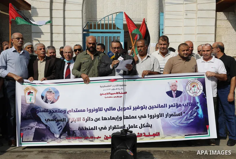 Palestinians take part in a protest in front of a United Nations-run health center, in Gaza city on November 17, 2021. Hundreds of refugees participated today in a protest to demand sustainable funding for the agency and...