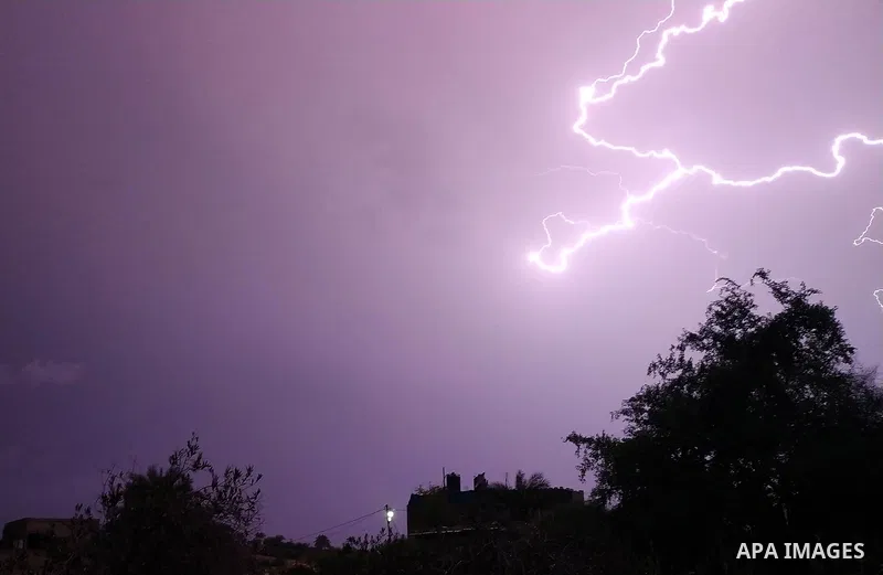 Lightning strikes is seen in the sky over Gaza city during a rainstorm on November 20, 2021. Photo by Ashraf Amra