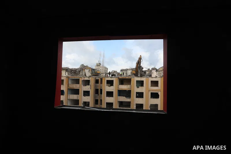 Palestinian workers remove the rubbles of al-Jawhara tower which was hit by Israeli strikes during the recent 11-day conflict between Israel and Hamas on May, in Gaza city on November 21, 2021. Photo by Ashraf Amra