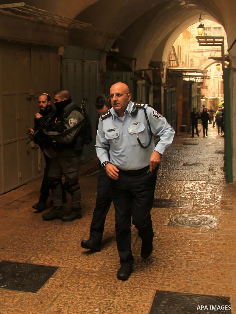 Israeli border guards stand guard behind a security perimeter at the scene of a shooting in the old city of Jerusalem on November 21, 2021. At least four people were wounded early on November 21, including two seriously,...