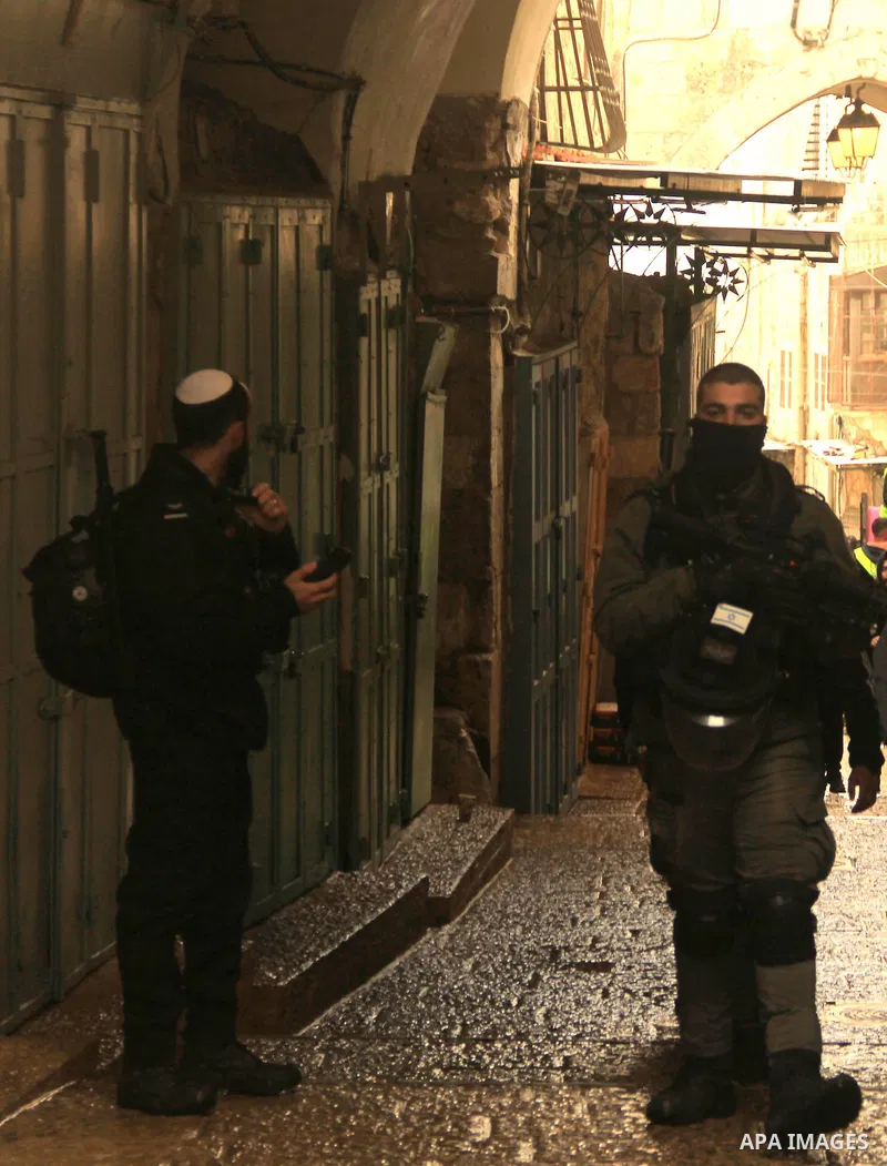 Israeli border guards stand guard behind a security perimeter at the scene of a shooting in the old city of Jerusalem on November 21, 2021. At least four people were wounded early on November 21, including two seriously,...