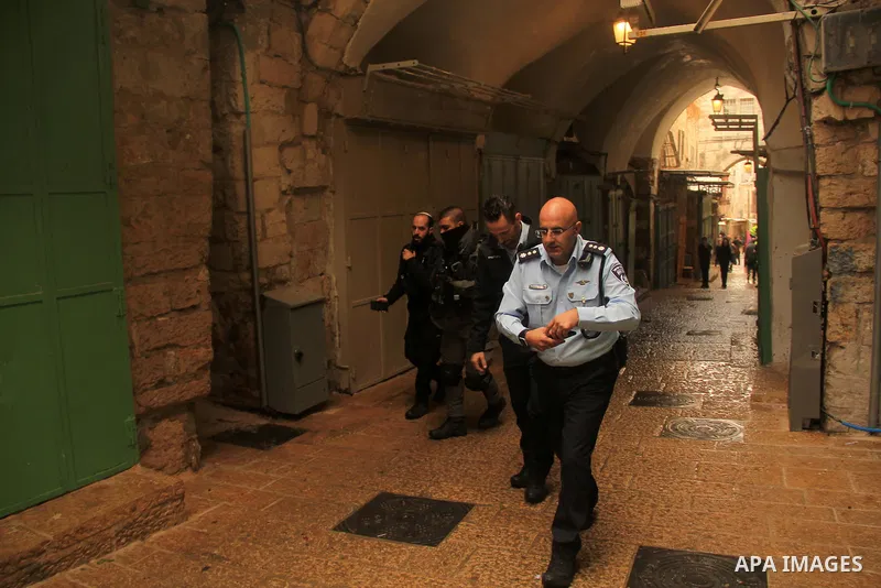 Israeli border guards stand guard behind a security perimeter at the scene of a shooting in the old city of Jerusalem on November 21, 2021. At least four people were wounded early on November 21, including two seriously,...