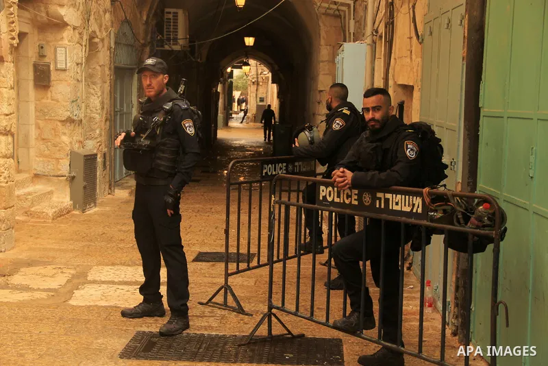 Israeli border guards stand guard behind a security perimeter at the scene of a shooting in the old city of Jerusalem on November 21, 2021. At least four people were wounded early on November 21, including two seriously,...