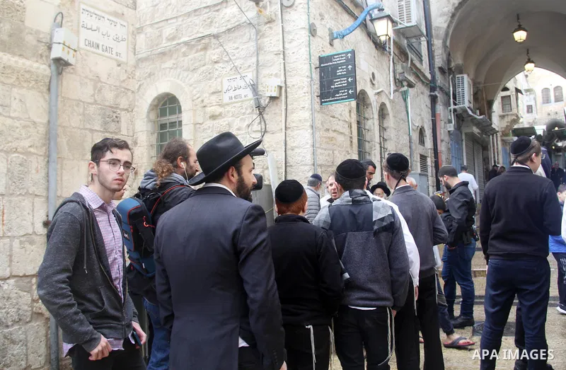 Israeli border guards stand guard behind a security perimeter at the scene of a shooting in the old city of Jerusalem on November 21, 2021. At least four people were wounded early on November 21, including two seriously,...