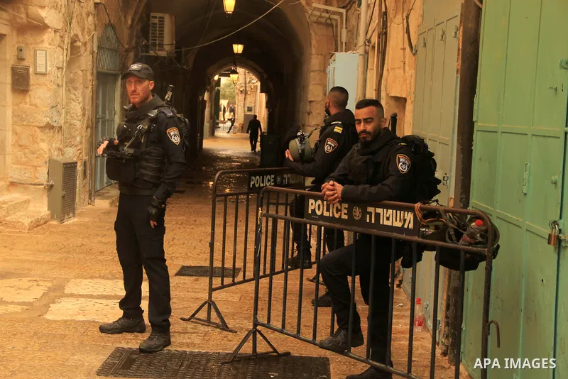 Israeli border guards stand guard behind a security perimeter at the scene of a shooting in the old city of Jerusalem on November 21, 2021. At least four people were wounded early on November 21, including two seriously,...