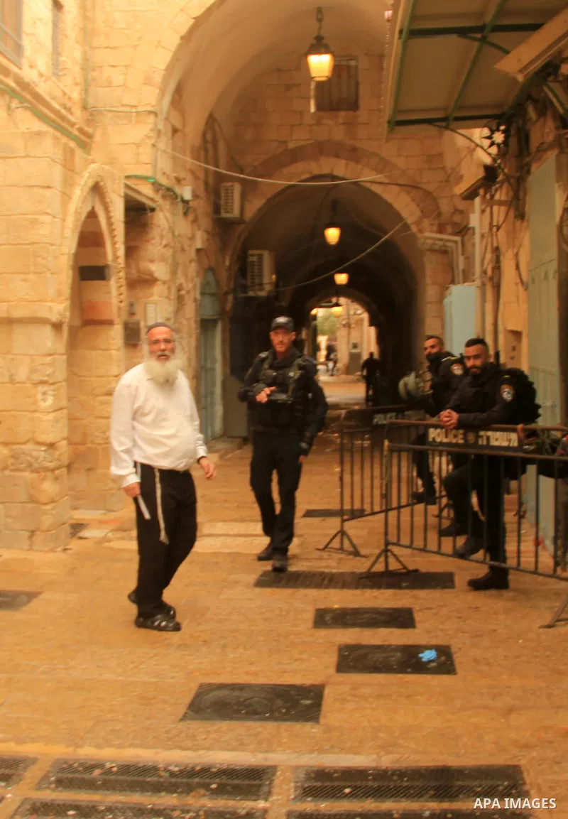Israeli border guards stand guard behind a security perimeter at the scene of a shooting in the old city of Jerusalem on November 21, 2021. At least four people were wounded early on November 21, including two seriously,...