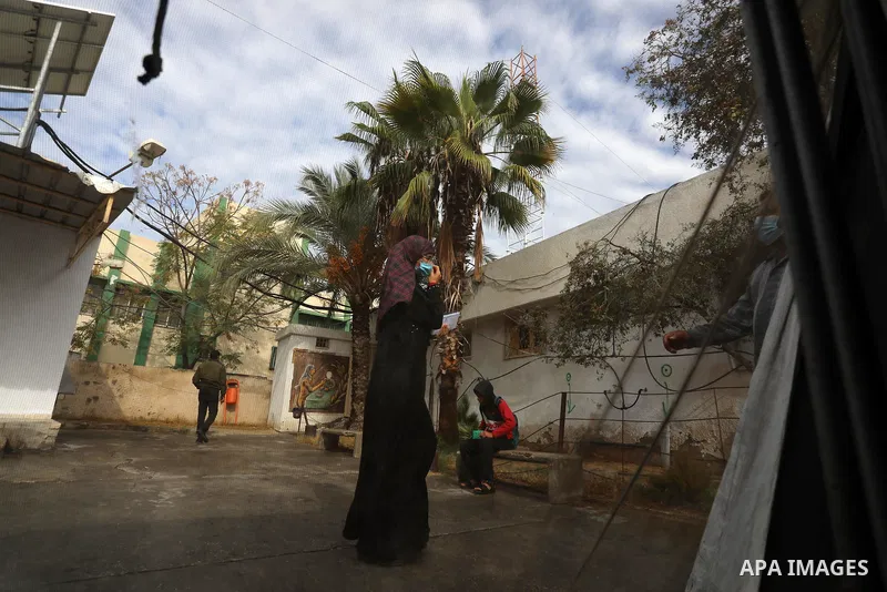 Palestinians get inoculated with a dose of the Covishield vaccine against the Covid-19 coronavirus, at a temporary vaccination centre set up, in Deir al-Balah in the center of Gaza Strip on November 211, 2021. Minister o...