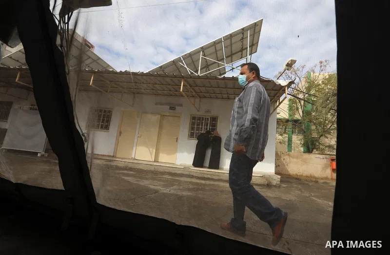 Palestinians get inoculated with a dose of the Covishield vaccine against the Covid-19 coronavirus, at a temporary vaccination centre set up, in Deir al-Balah in the center of Gaza Strip on November 211, 2021. Minister o...