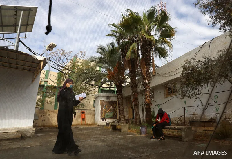 Palestinians get inoculated with a dose of the Covishield vaccine against the Covid-19 coronavirus, at a temporary vaccination centre set up, in Deir al-Balah in the center of Gaza Strip on November 211, 2021. Minister o...