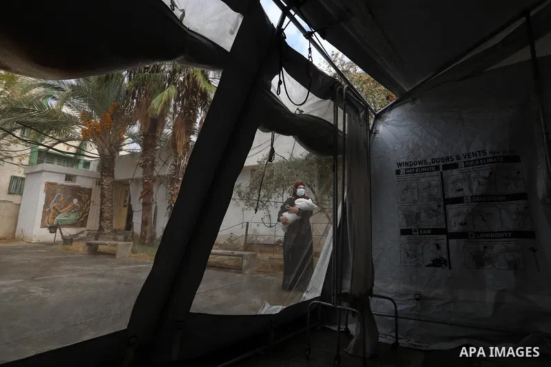 Palestinians get inoculated with a dose of the Covishield vaccine against the Covid-19 coronavirus, at a temporary vaccination centre set up, in Deir al-Balah in the center of Gaza Strip on November 211, 2021. Minister o...