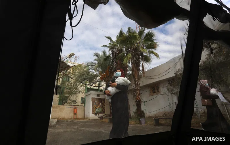 Palestinians get inoculated with a dose of the Covishield vaccine against the Covid-19 coronavirus, at a temporary vaccination centre set up, in Deir al-Balah in the center of Gaza Strip on November 211, 2021. Minister o...