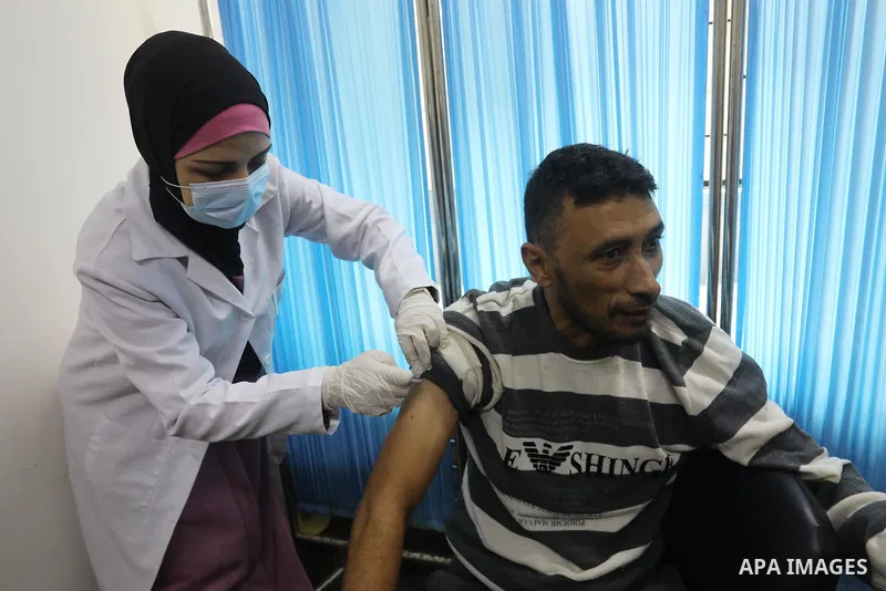 Palestinians get inoculated with a dose of the Covishield vaccine against the Covid-19 coronavirus, at a temporary vaccination centre set up, in Deir al-Balah in the center of Gaza Strip on November 211, 2021. Minister o...