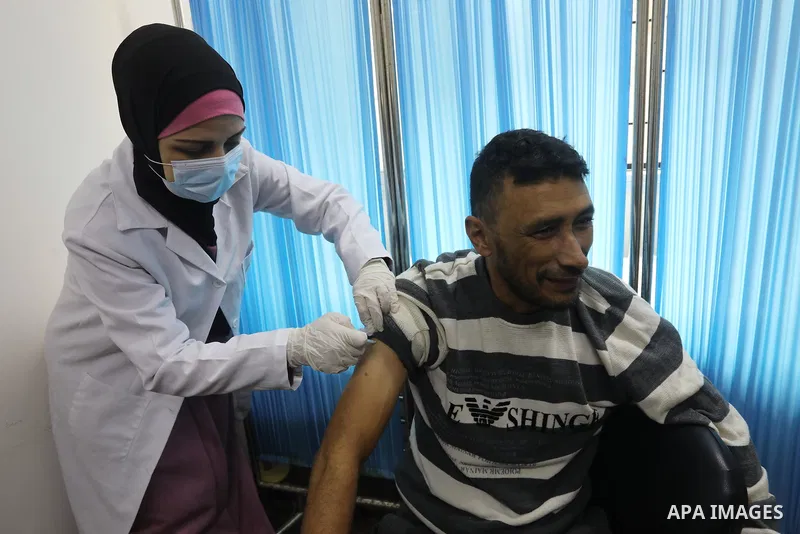Palestinians get inoculated with a dose of the Covishield vaccine against the Covid-19 coronavirus, at a temporary vaccination centre set up, in Deir al-Balah in the center of Gaza Strip on November 211, 2021. Minister o...